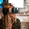 Woman wearing VR headset at counter at SXSW 2015